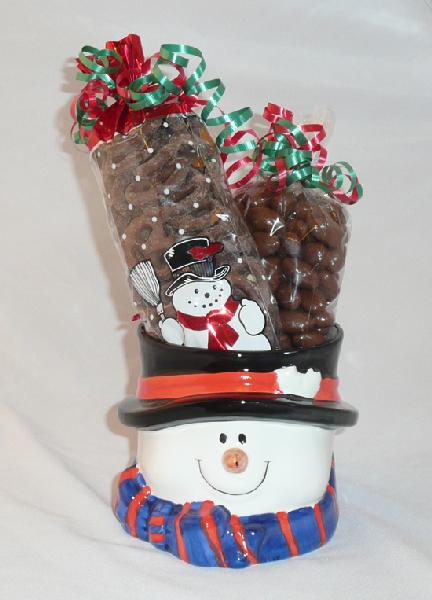 Ceramic Snowman - A ceramic snowman filled with over  pound of chocolate covered pretzels and  pound of chocolate covered almonds decorated with festive colored ribbons.